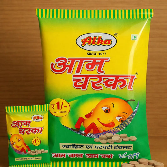 Alka brand Aam Chaska packaging with a yellow and green color scheme on a wooden background